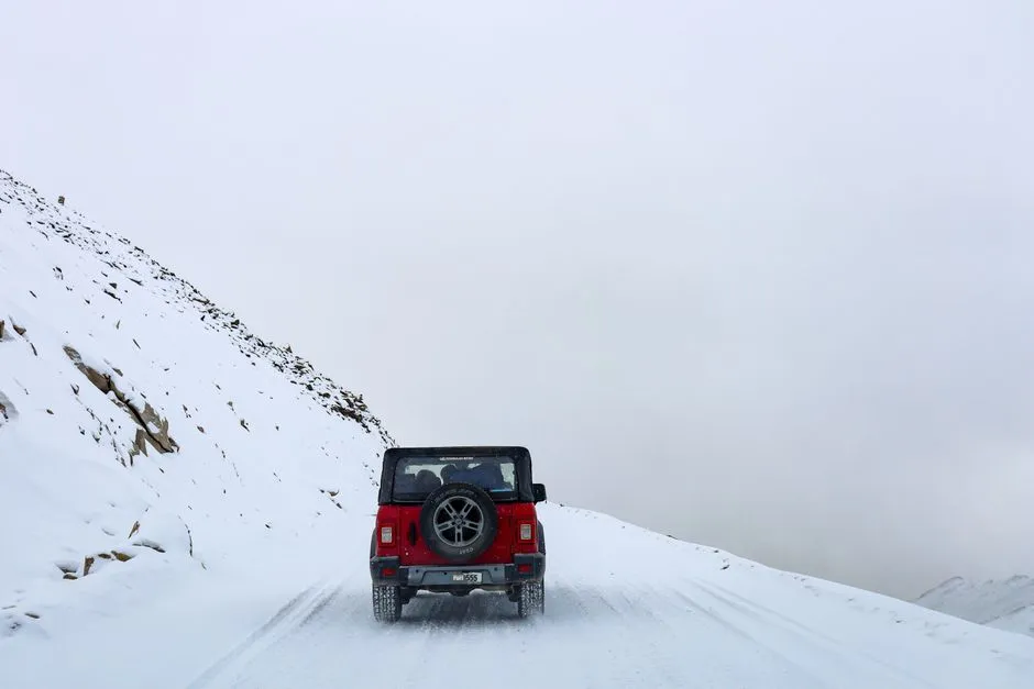 Car driving on a snow-covered mountain road