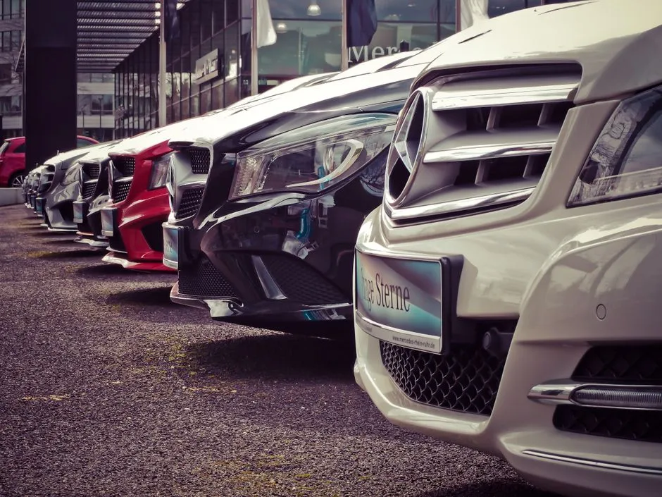 Rental cars parked in a row at an airport rental lot